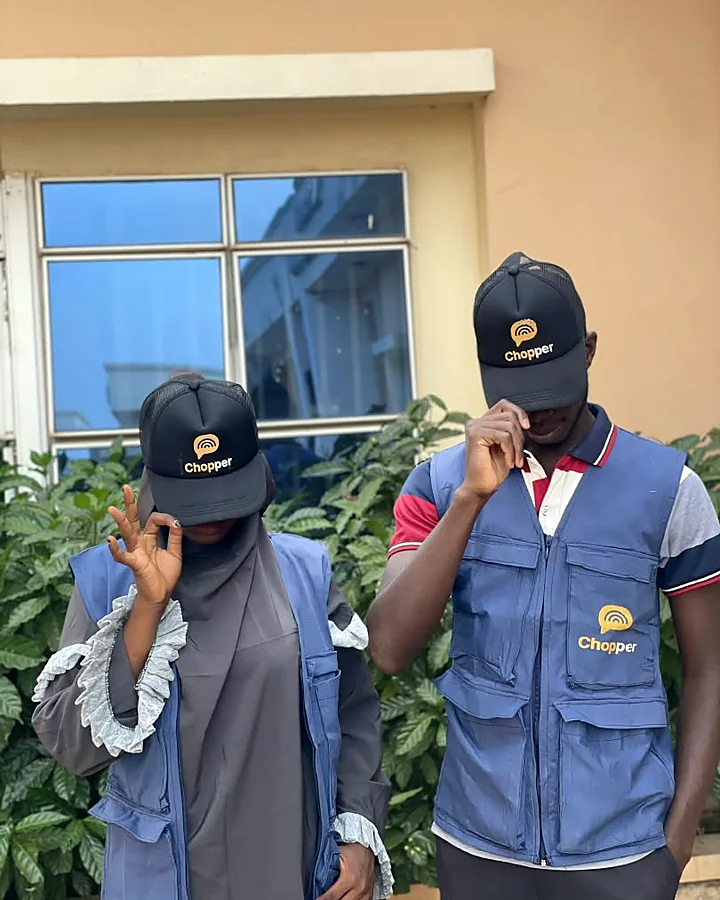 Two ChopChat team members in Chopper caps and blue vests, each tipping their cap.